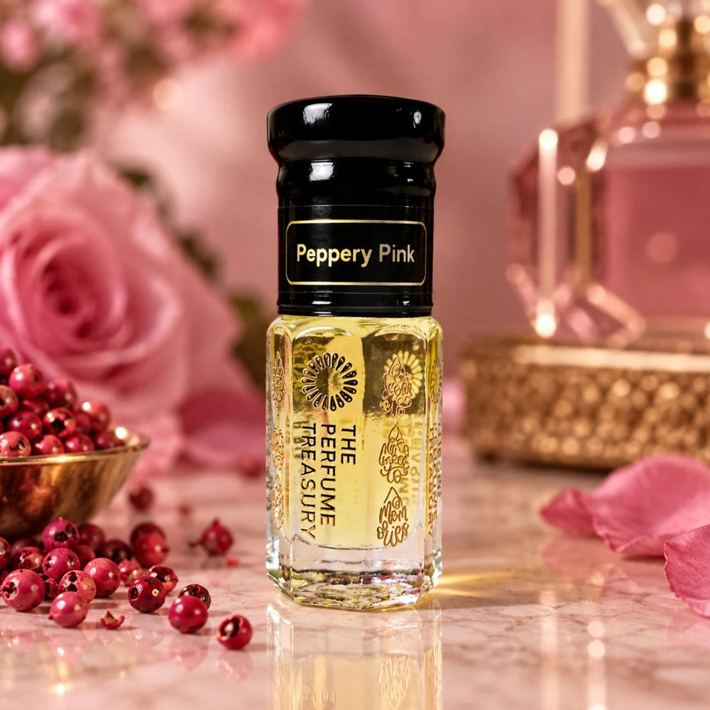 Peppery Pink perfume oil by The Perfume Treasury displayed with pink peppercorns, pink roses and luxurious fragrance accents.