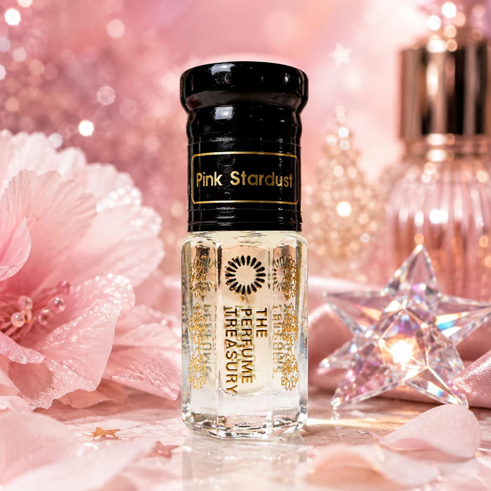 Pink Stardust perfume oil by The Perfume Treasury displayed with soft pink flowers, shimmering stars and sparkling crystal accents.