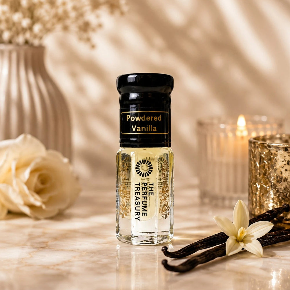 Powdered Vanilla perfume oil by The Perfume Treasury displayed with vanilla pods, vanilla flowers, cream roses and warm candlelight.
