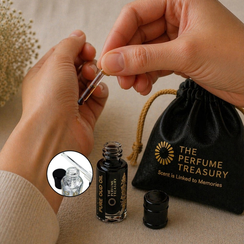 Applying dark Pure Oud perfume oil with glass applicator by The Perfume Treasury, highlighting rich and intense fragrance oil texture.