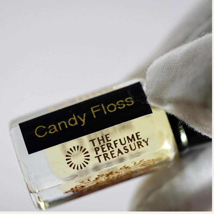 Close-up of Candy Floss perfume oil showing soft golden liquid and premium bottle detail.