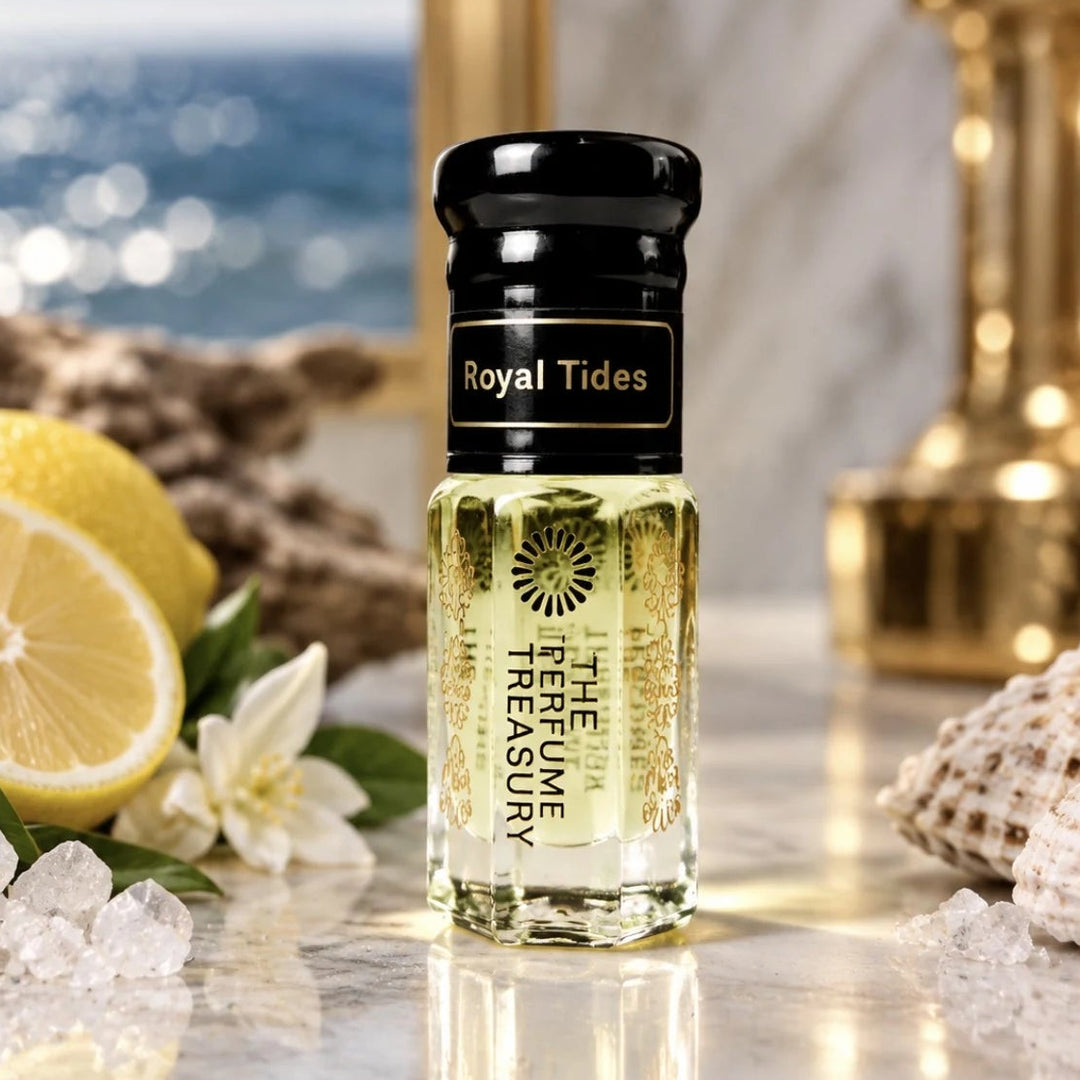 Royal Tides perfume oil by The Perfume Treasury displayed in a luxurious coastal setting with lemon, white blossoms, seashells and sparkling ocean views.