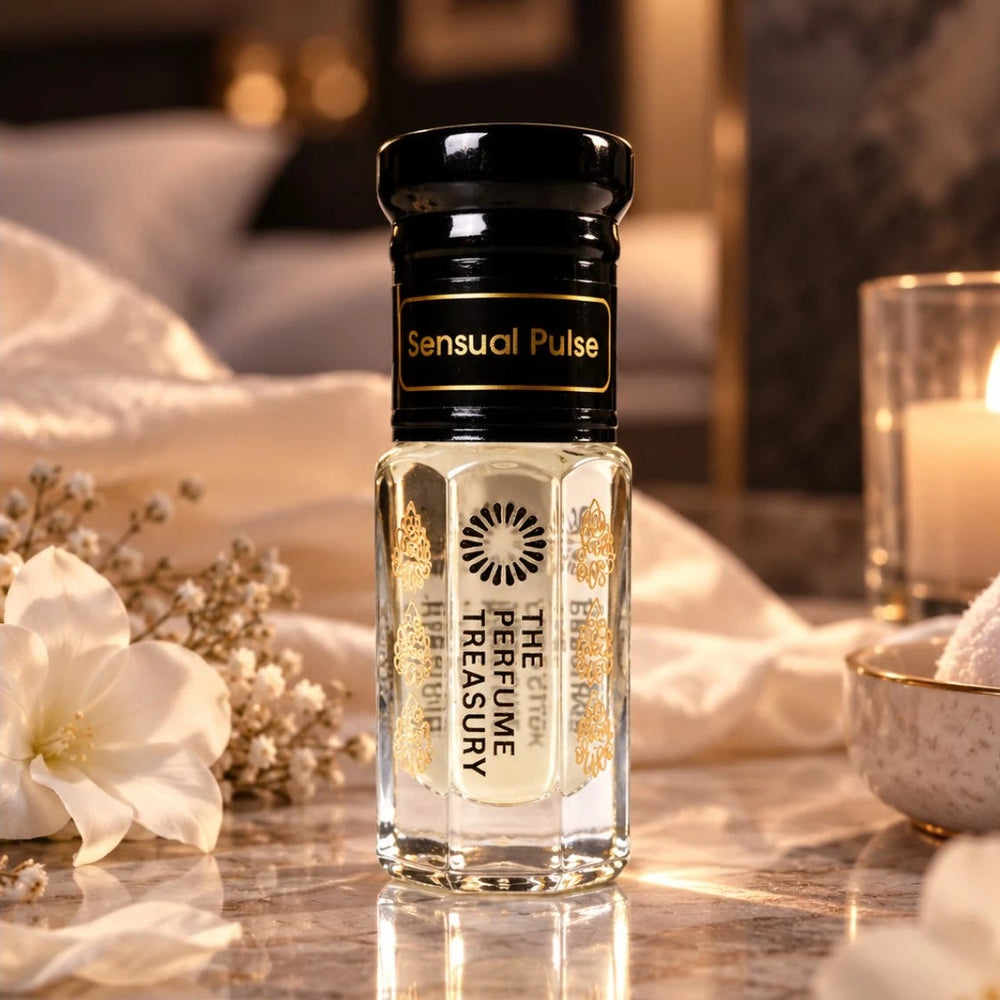 Sensual Pulse perfume oil by The Perfume Treasury displayed in an intimate luxury setting with white flowers, soft satin, marble and warm candlelight.