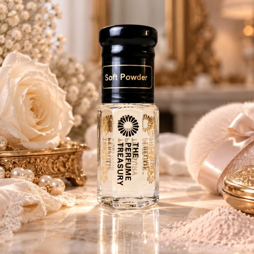 Soft Powder luxury perfume oil by The Perfume Treasury in a clear glass bottle with glossy black lid, displayed with a white rose, pearls, powder puff, lace and cosmetic powder in an elegant softly lit setting