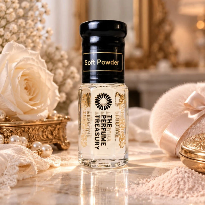 Soft Powder luxury perfume oil by The Perfume Treasury in a clear glass bottle with glossy black lid, displayed with a white rose, pearls, powder puff, lace and cosmetic powder in an elegant softly lit setting