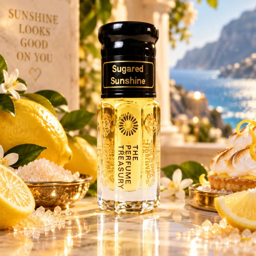 Sugared Sunshine perfume oil by The Perfume Treasury displayed with fresh lemons, sugar crystals, white flowers and lemon dessert in a bright Mediterranean coastal setting