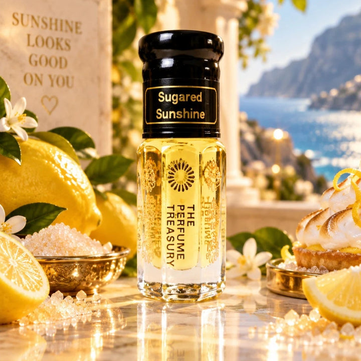 Sugared Sunshine perfume oil by The Perfume Treasury displayed with fresh lemons, sugar crystals, white flowers and lemon dessert in a bright Mediterranean coastal setting