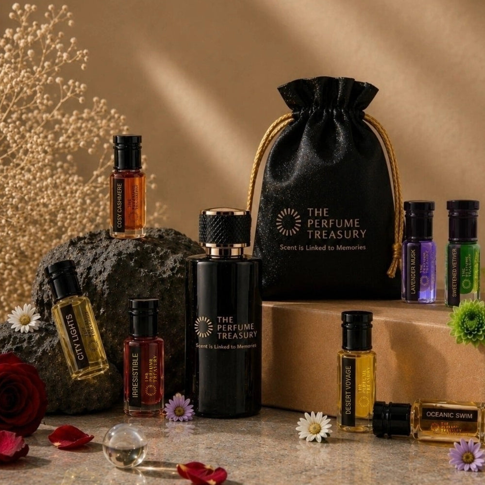 Luxury fragrance collection by The Perfume Treasury featuring perfume oils, essential oils, extrait de parfum, gift pouch and elegant floral display with premium presentation.