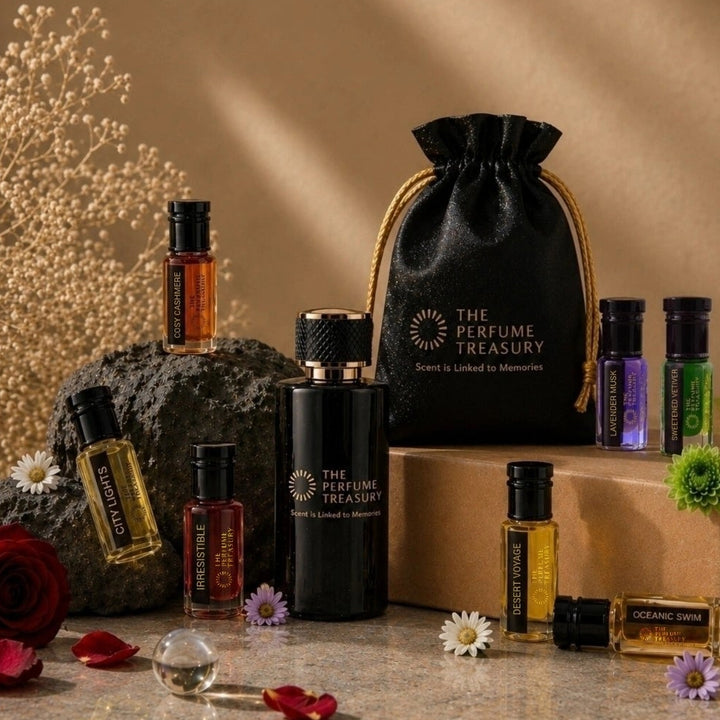 Luxury fragrance collection by The Perfume Treasury featuring perfume oils, essential oils, extrait de parfum, gift pouch and elegant floral display with premium presentation.