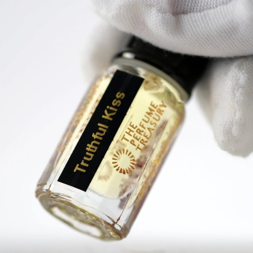 Close-up of Truthful Kiss perfume oil by The Perfume Treasury showing the bottle and black and gold label