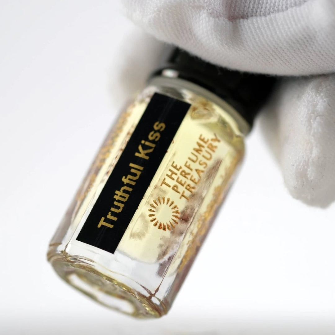 Close-up of Truthful Kiss perfume oil by The Perfume Treasury showing the bottle and black and gold label