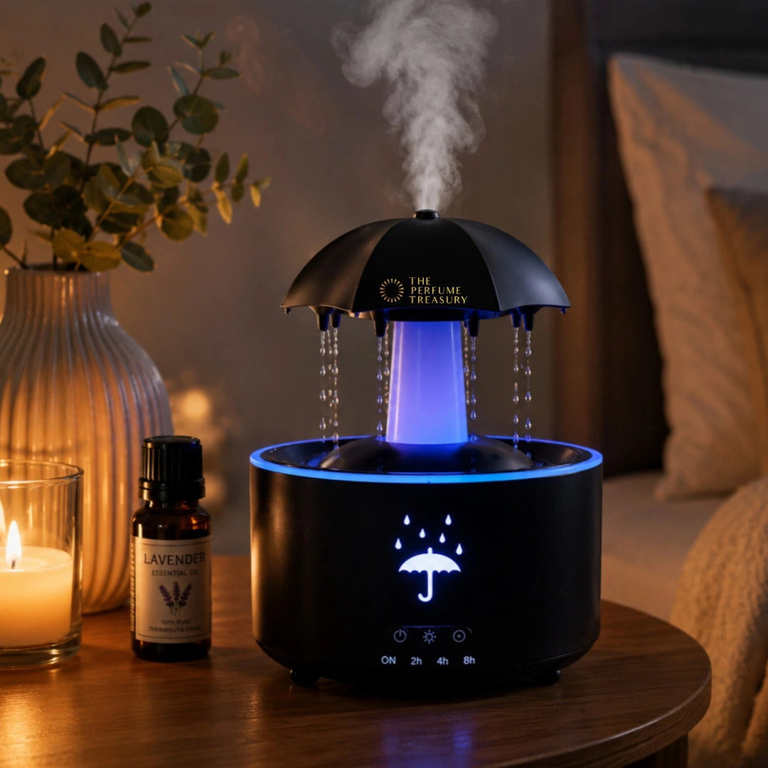 Cozy bedside lifestyle scene featuring umbrella ultrasonic diffuser with blue LED glow, realistic rainfall droplets and relaxing aromatherapy mist beside candle and essential oil.