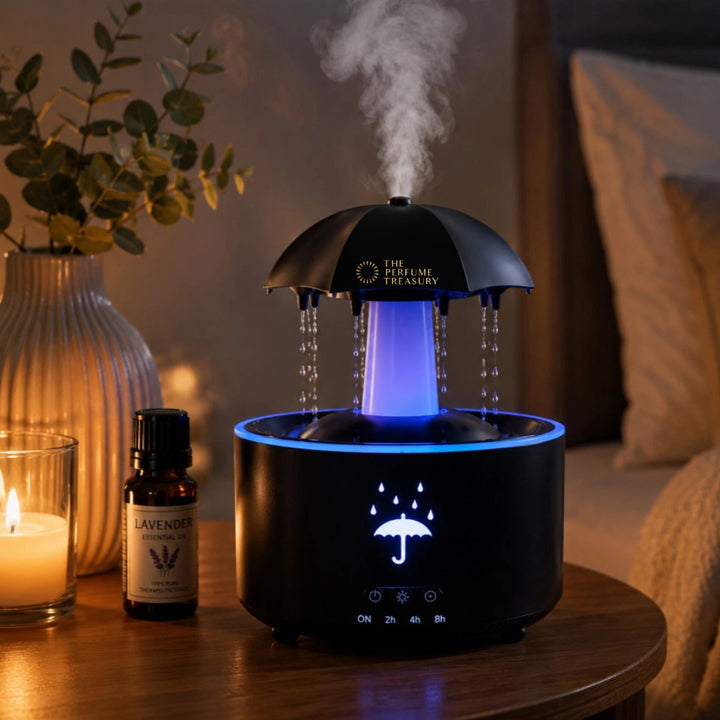 Cozy bedside lifestyle scene featuring umbrella ultrasonic diffuser with blue LED glow, realistic rainfall droplets and relaxing aromatherapy mist beside candle and essential oil.