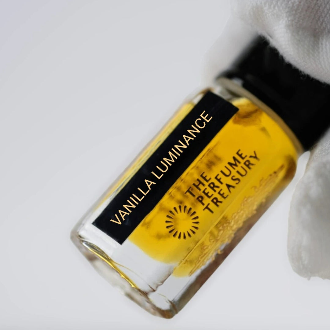Close-up of Vanilla Luminance perfume oil by The Perfume Treasury showing the rich golden oil and branded bottle label