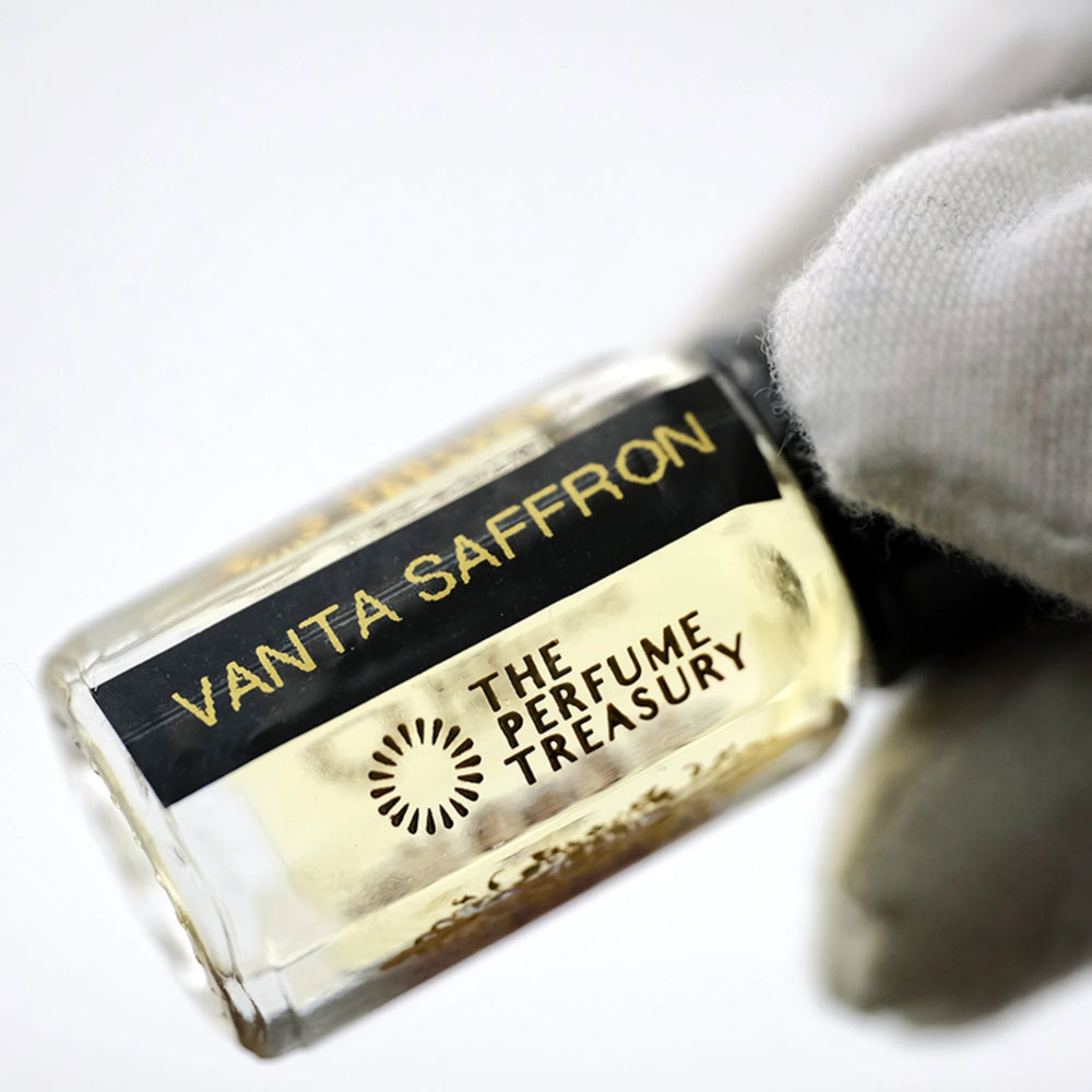Close-up of Vanta Saffron perfume oil by The Perfume Treasury showing the pale golden oil and branded bottle label