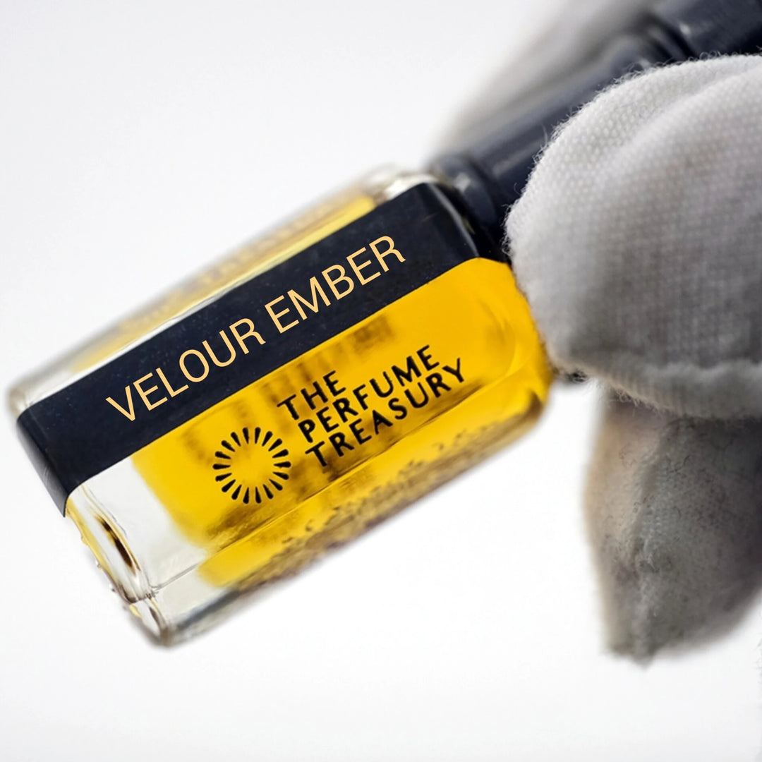 Close-up of Velour Ember perfume oil by The Perfume Treasury showing the rich golden oil and branded bottle label