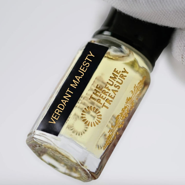 Close-up of Verdant Majesty perfume oil by The Perfume Treasury showing the pale golden oil and branded bottle label