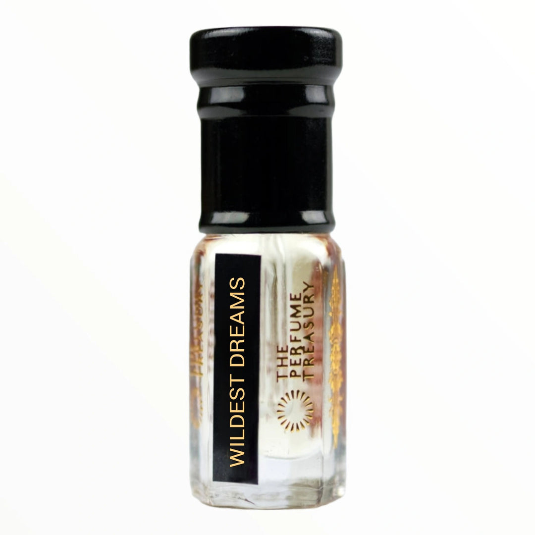 Small clear glass perfume oil bottle with black cap, Wildest Dreams 3ml attar perfume oil by The Perfume Treasury, clear to lightly tinted smooth fragrance oil on white background.